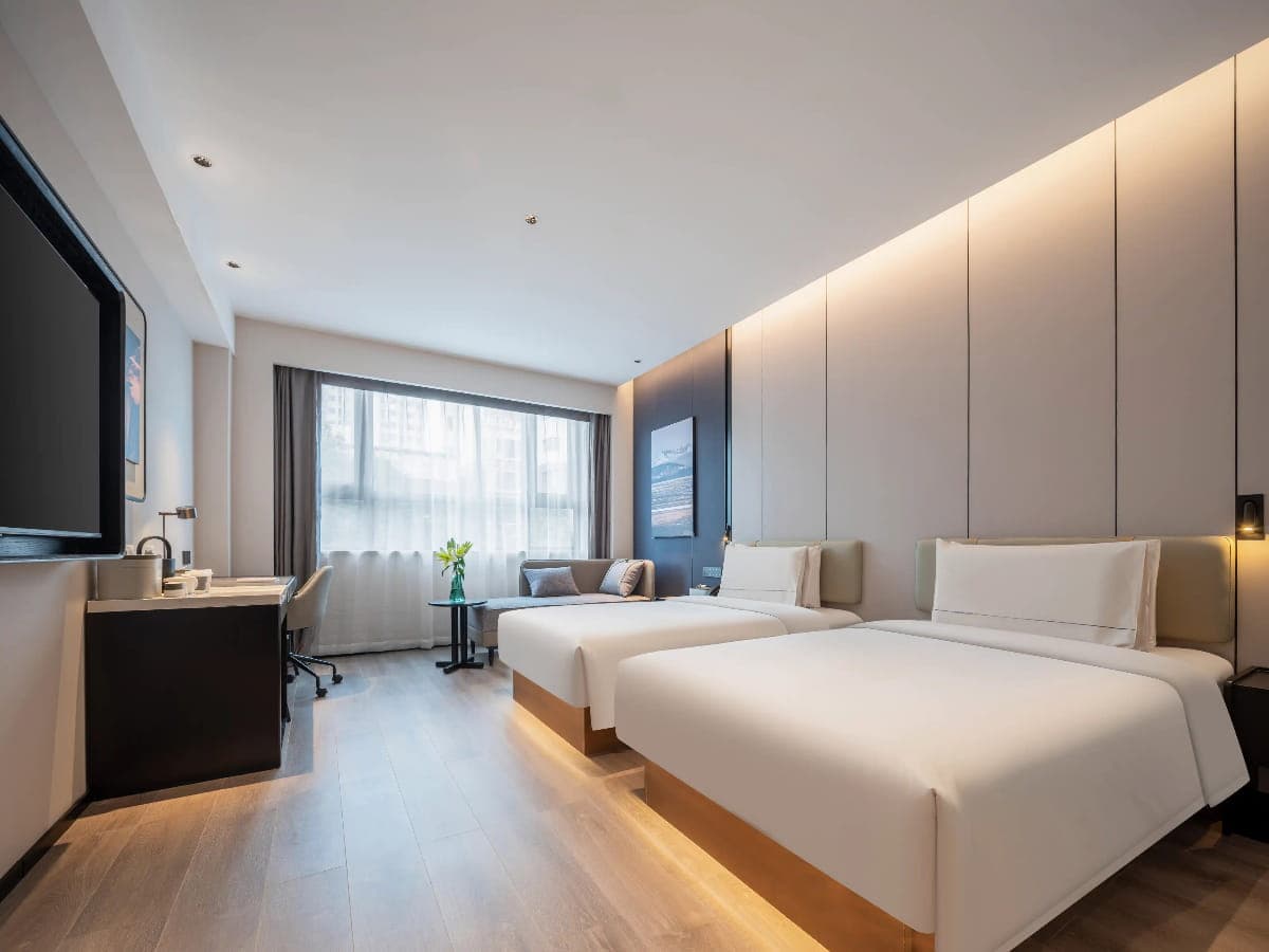 Hotel room with two beds and a seating area